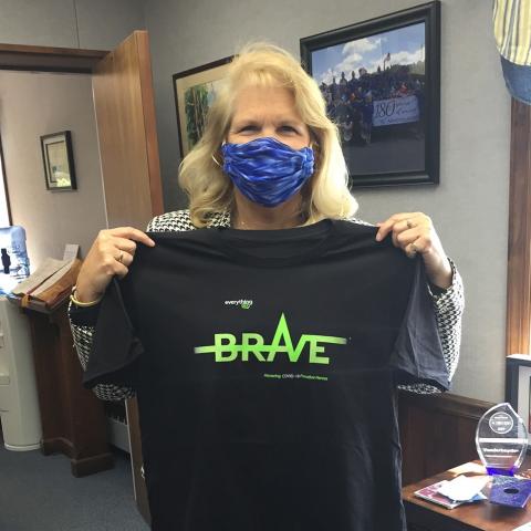 Vanderheyden CEO/President Karen Carpenter-Palumbo, displaying her 'BRAVE' T-Shirt honoring COVID-19 Frontline Heroes