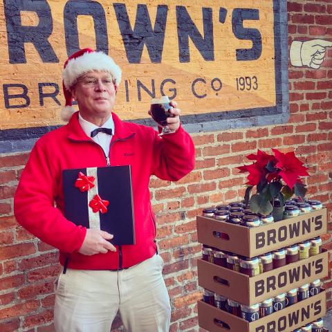 Keith Slupski raises a pint of Brown's Brewing Company's Dunder & Blixem Strong Ale