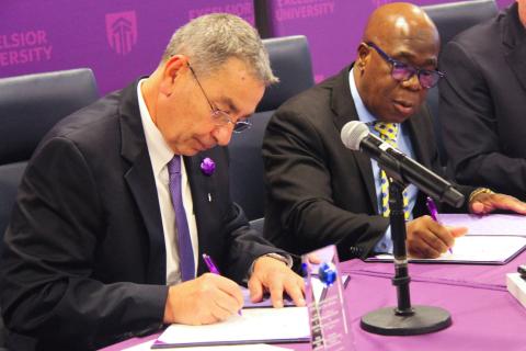 Excelsior University President David Schejbal (left) and Kouamé N’guessan, Côte d’Ivoire economic advisor in charge of attractiveness and investment (right) sign a partnership agreement between Excelsior University and the Virtual University of Côte d’Ivoire. 